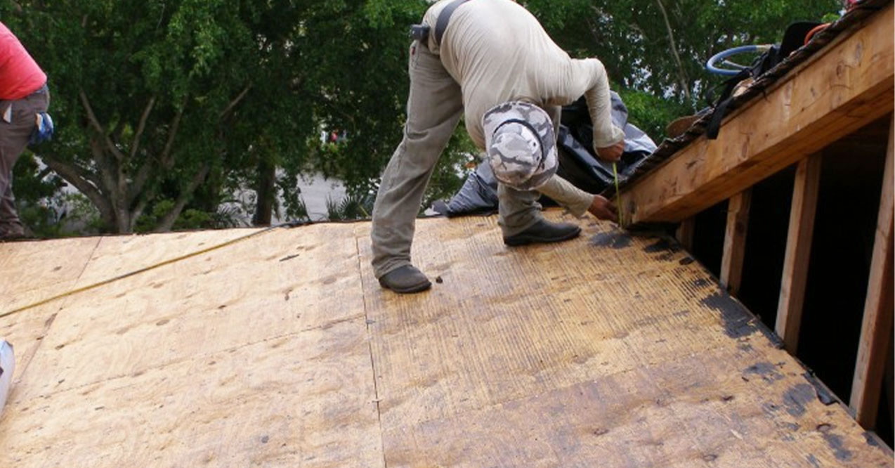 Contractor Doing a Tile Roof Replacement | Atlantis Roofing of Naples, Inc.