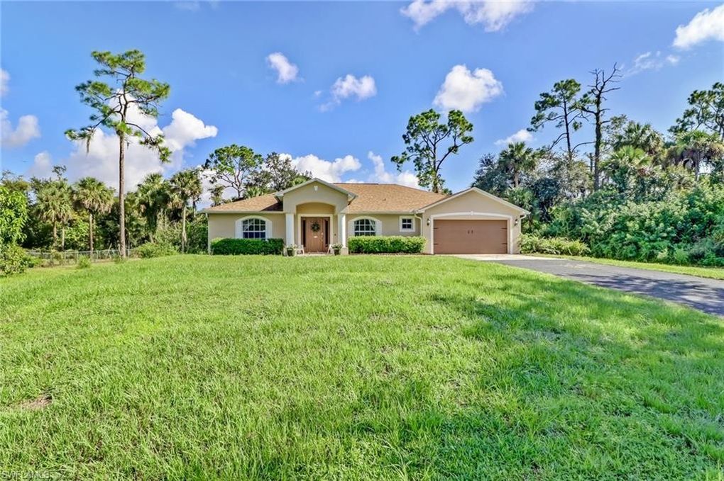 Beige House with Tan Shingle Roof | Atlantis Roofing of Naples, Inc.